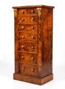 An early 20th century burr walnut seven graduating drawer Wellington chest.