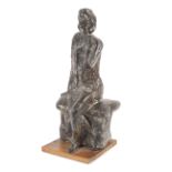 A 20th century sculpture of a seated lady.