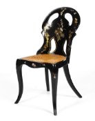 A Victorian black lacquered and mother of pearl inlaid chair.