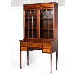 An Edwardian inlaid mahogany astragal glazed bookcase-writing desk.