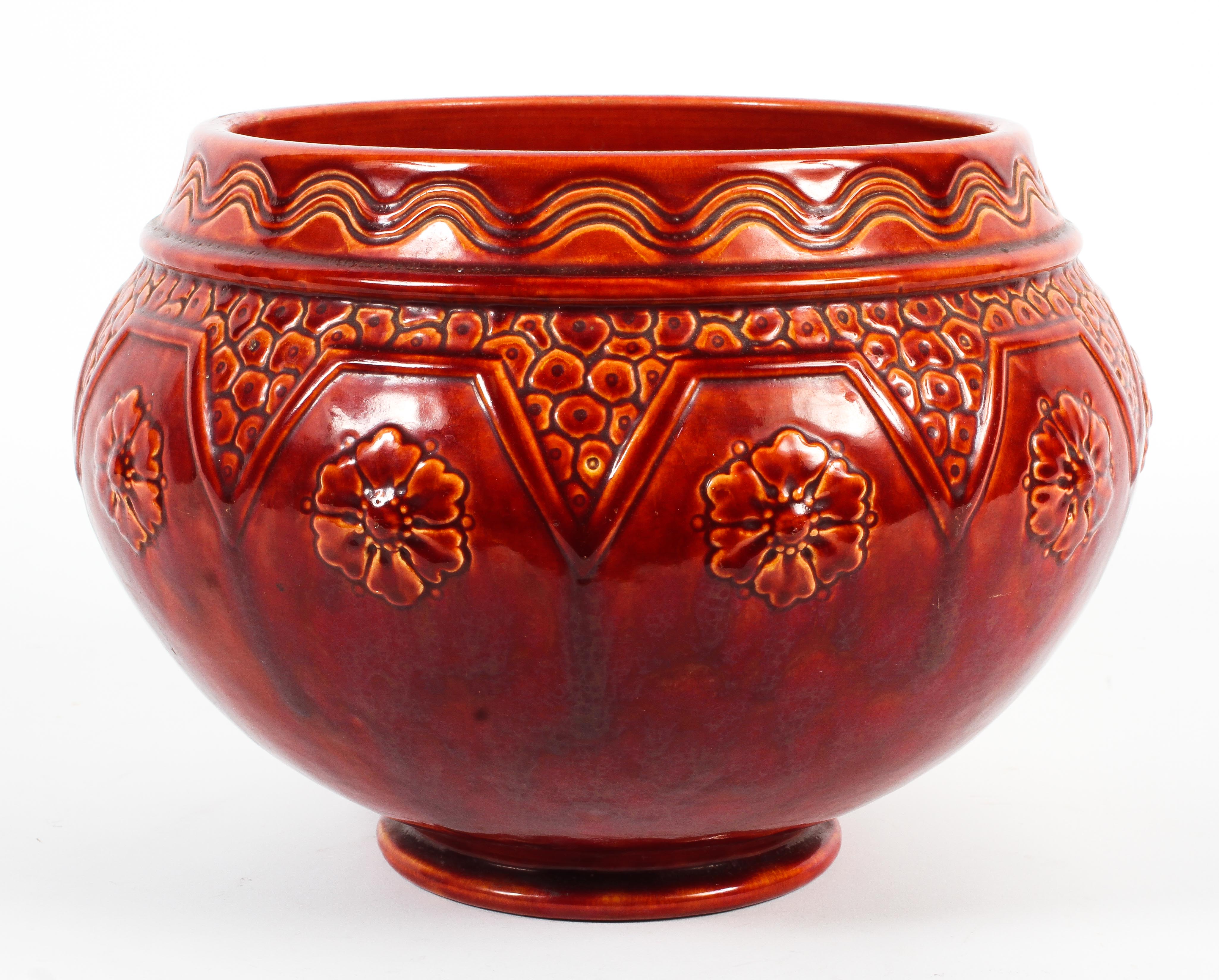 A late 19th century Burmantofts faience red glazed jardiniere.