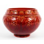 A late 19th century Burmantofts faience red glazed jardiniere.