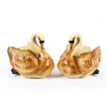 A pair of late 19th century pottery swan jardinieres.