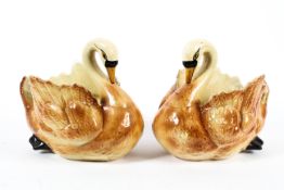 A pair of late 19th century pottery swan jardinieres.