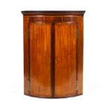 A Georgian mahogany inlaid corner cupboard.