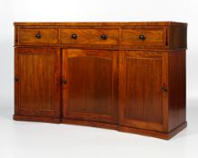 An early 19th century mahogany concave shaped sideboard.