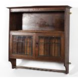 An Arts and crafts heals oak glazed wall cabinet.