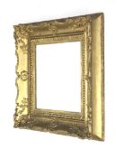 A fine 19th century wood and plaster gilded swept picture frame.