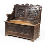 A 19th century carved oak monk's bench.