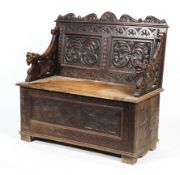 A 19th century carved oak monk's bench.