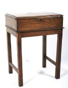 An 18th century elm bible box on a later oak stand.