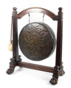 A large mid-19th century bronze dinner gong on mahogany frame.