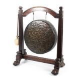 A large mid-19th century bronze dinner gong on mahogany frame.