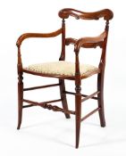 An Edwardian kitchen elbow chair.