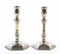 A pair of Georgian seamed brass candlesticks.