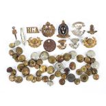 A collection of assorted military and other buttons and badges.