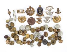 A collection of assorted military and other buttons and badges.