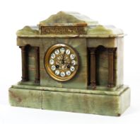 A late 19th/early 20th century French onyx eight-day mantel clock.