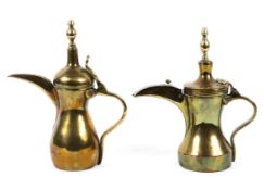 Two Middle Eastern brass coffee-pots.