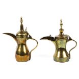 Two Middle Eastern brass coffee-pots.