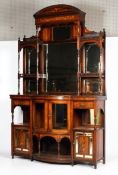 An Edwardian Sheraton Revival marquetry inlaid rosewood sideboard.