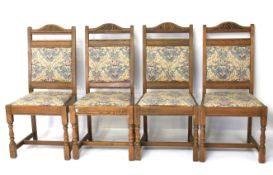 Four contemporary stained oak dining chairs.