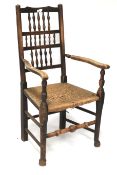 A 19th century oak rush seated ladderback elbow chair.
