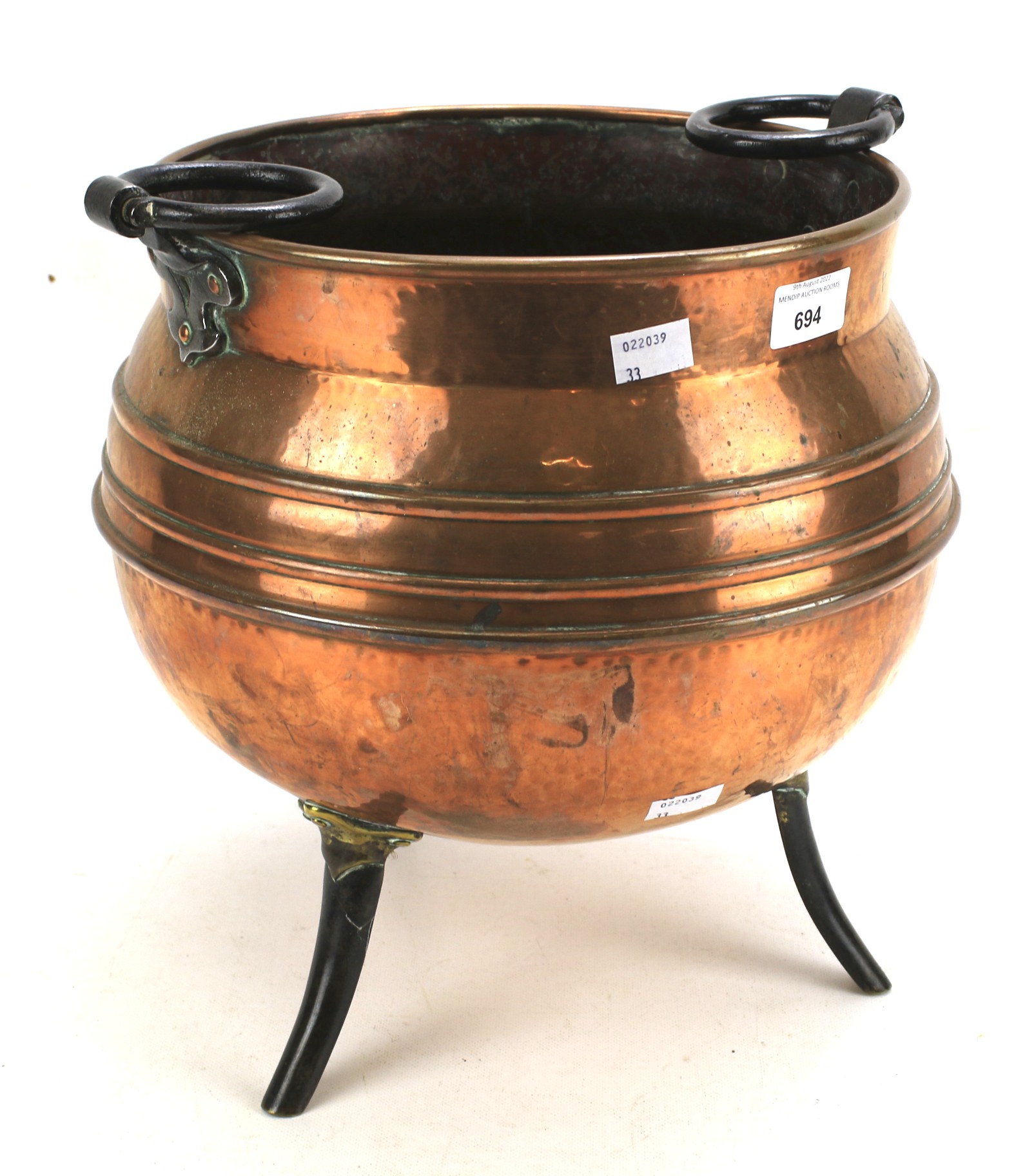 A beaten copper cauldron.