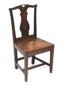 A 19th century oak chair. With shaped splat and splayed seat, on square tapering supports. H93cm.