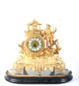 A 20th century gilt-metal mantel clock on an ebonised base and under a glass dome.