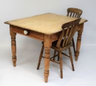 A pine scrub-top breakfast table and two chairs.