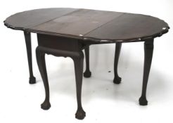 An African hardwood gate leg dining table.