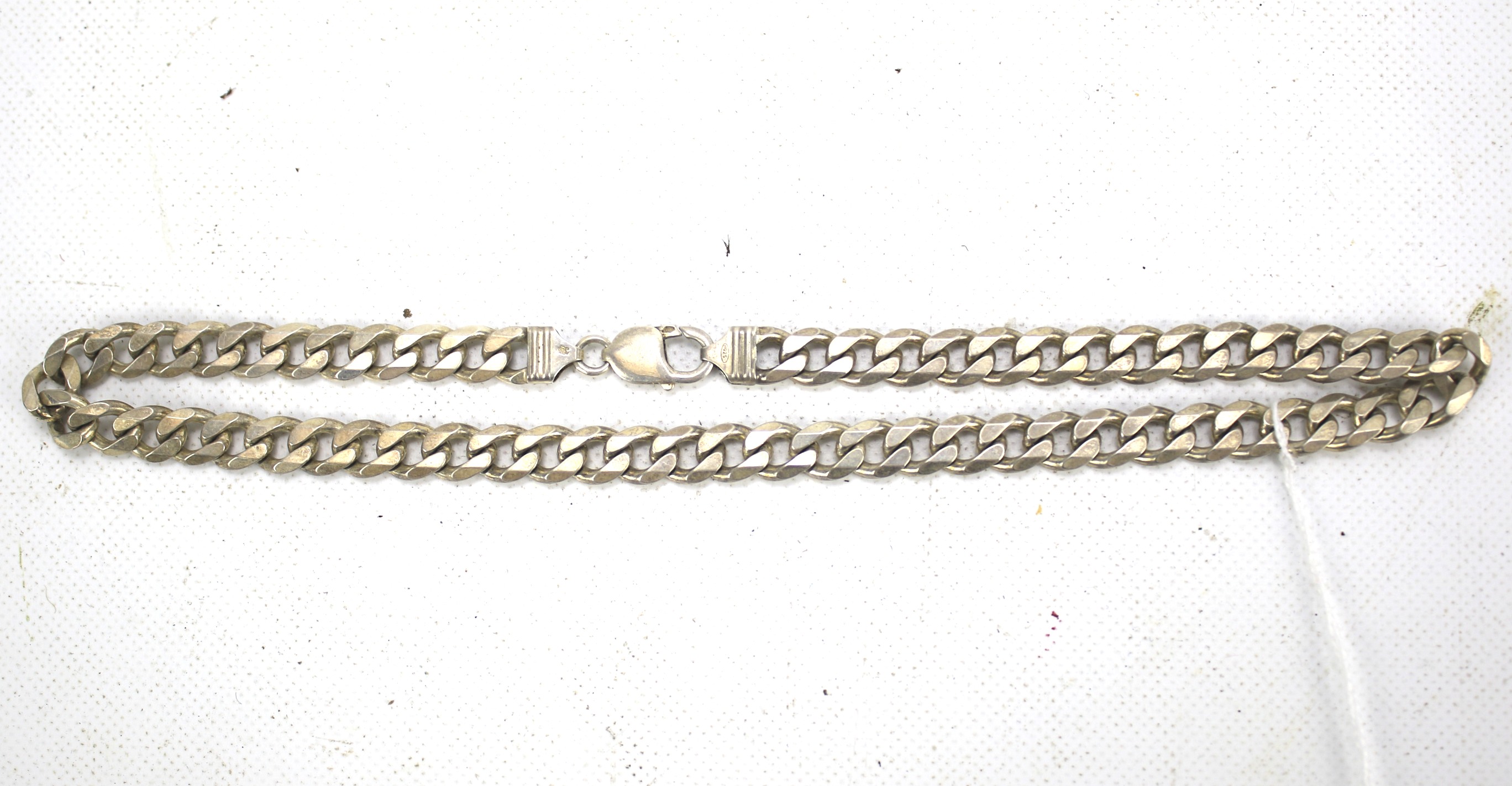 A white metal curb link chain.