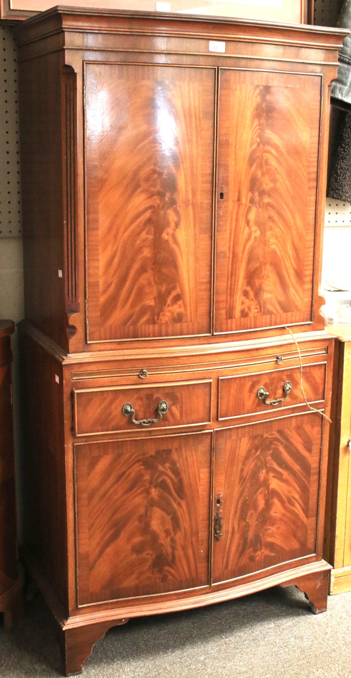 A reproduction mahogany cupboard.