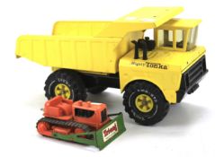 A Tonka toy tipping truck and a Tri-ang Minic plough.