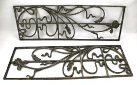 Two cast metal window decorations.