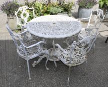 An early 20th century cast metal white painted garden table and four chairs.