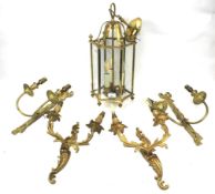 A metal framed hallway hanging light and two pairs of gilt wall sconces.