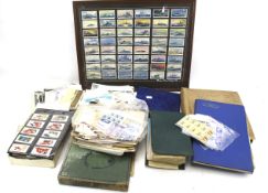 An assortment of cigarette cards and post cards.