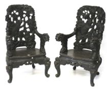 A pair of contemporary black lacquered wooden chairs.