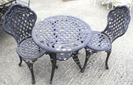 A 20th century black painted aluminum garden table and two chairs.