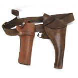 Two leather gun holsters and another pouch.