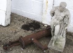 A 20th century cast metal water pump and a composite garden figure.