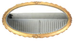 A large oval giltwood and gesso mirror, early 20th century.