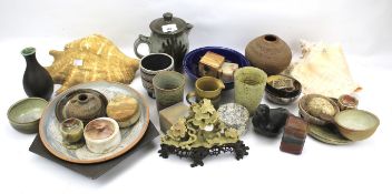 An assortment of pottery, stone wares and shells.