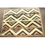 An Ethnic style woolen floor rug with geometric pattern,