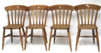 A set of four pine kitchen chairs.