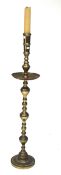 A large brass candlestick with impressed decoration.