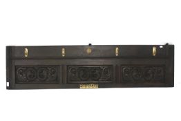 A stained 19th century panel converted into a key and coat rack.