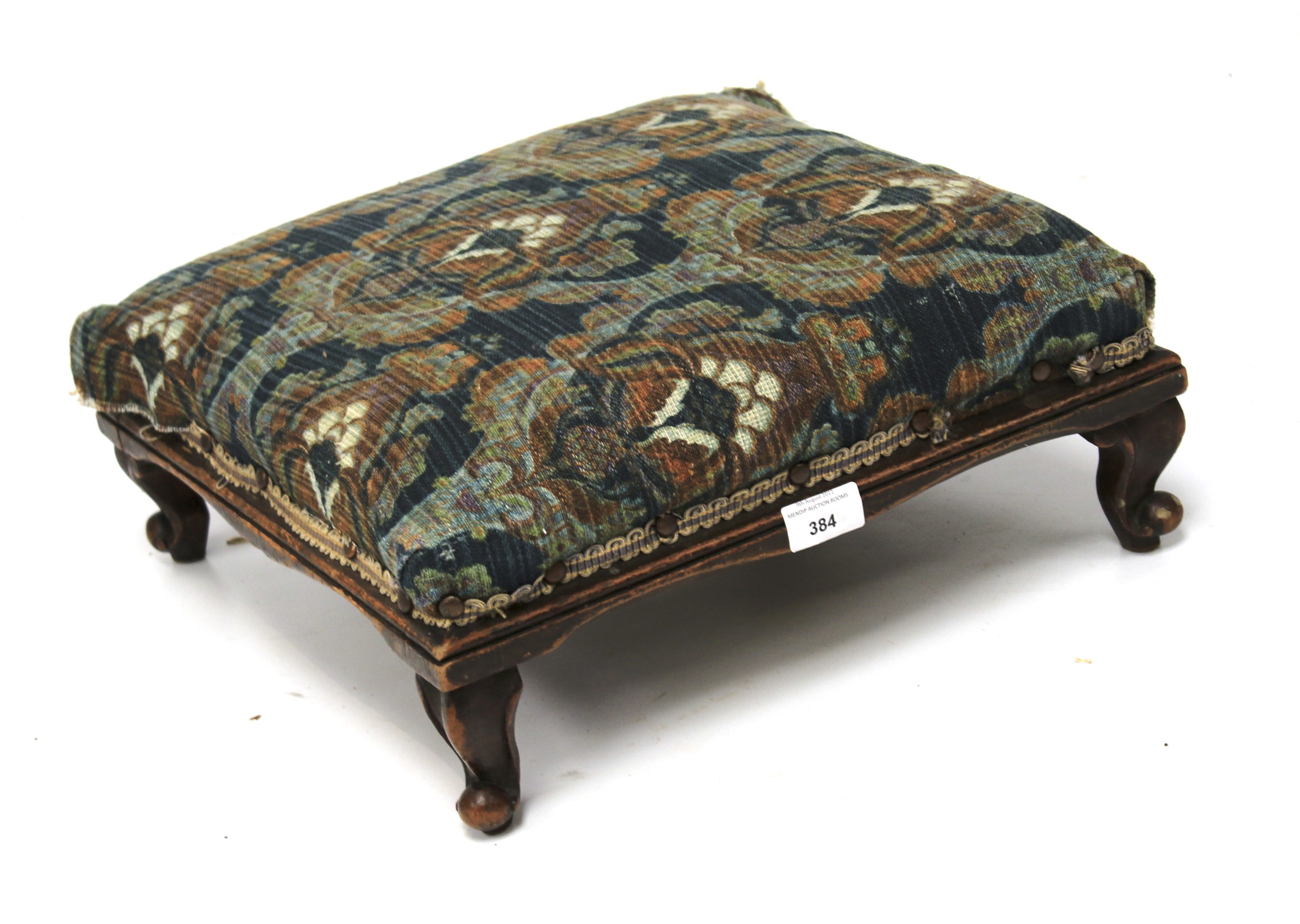 An upholstered footstool.